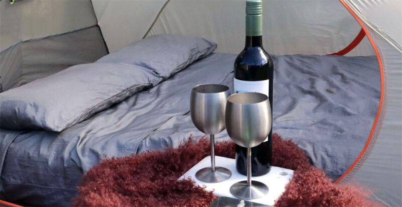 dingotex eco-friendly sheet set on camping mattress in silver moon colour with wine glasses and bottle in foreground