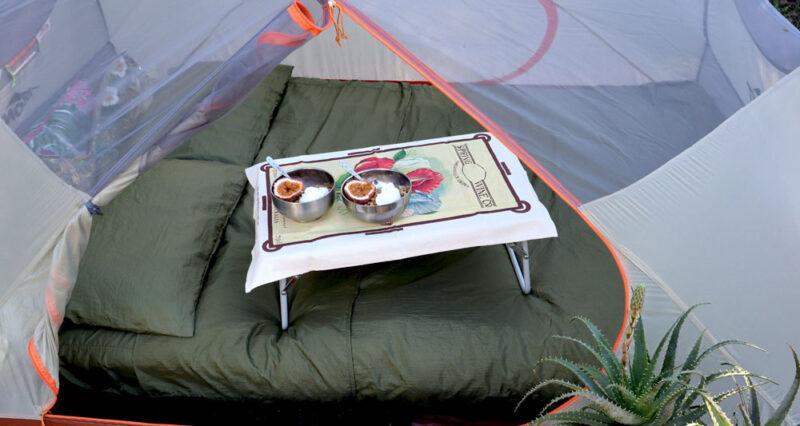 dingotex eco-friendly travel sheet in gumleaf green with breakfast table on bed